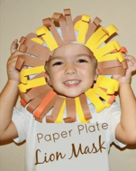 Child holding paper plate decorated to look like a lion's mane