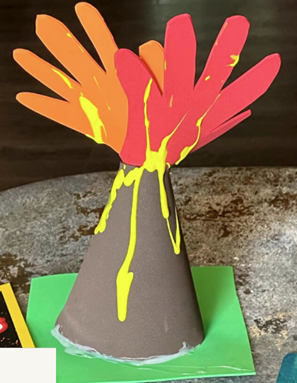 Craft volcano made with two handprints cut out of foam, a foam cone, and yellow paint