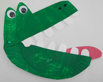 Paper plate painted green, with googly eyes, and construction paper teeth and tongue designed to look like an alligator