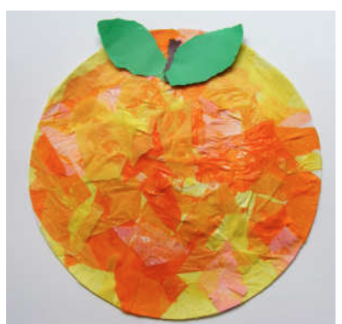 A paper plate covered with orange and yellow tissue paper with a brown stem and 2 green leaves. 