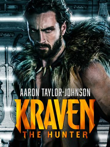 A dramatic movie poster featuring a muscular, bearded man with long dark hair pulled back, wearing a fur-lined vest and a necklace made of animal teeth. He looks directly at the viewer with a serious, intense expression. The background appears metallic and industrial, with weapons mounted on the wall behind him. Large bold text across the lower half of the image reads “KRAVEN THE HUNTER.” Smaller text above the title reads “AARON TAYLOR-JOHNSON.”