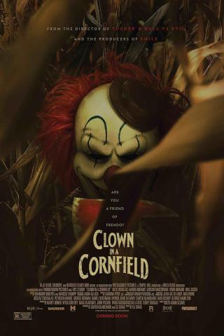 A dark horror movie poster for Clown in a Cornfield shows a sinister clown with red hair and white face paint partially hidden among tall cornstalks. The clown’s head tilts downward, creating a shadowed, ominous expression. Above the title, small text reads “Are you a friend of Frendo?” Large distressed lettering near the bottom reads “Clown in a Cornfield,” with production credits and the words “Coming Soon” below.