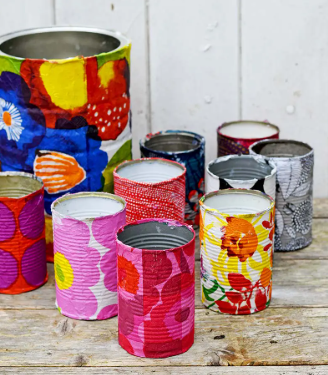 This image is of a variety of empty tin cans that have been painted in bright, floral patterns.