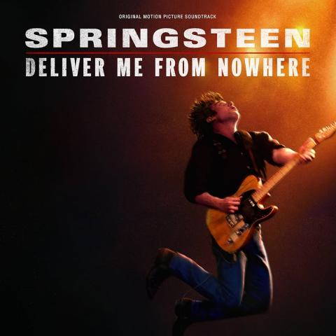 An album-style poster for Springsteen: Deliver Me From Nowhere shows a musician mid-jump while playing an electric guitar under warm stage lighting. The background fades from dark to orange, suggesting a live concert atmosphere. Large text at the top reads “Springsteen: Deliver Me From Nowhere,” with smaller text above stating “Original Motion Picture Soundtrack.”
