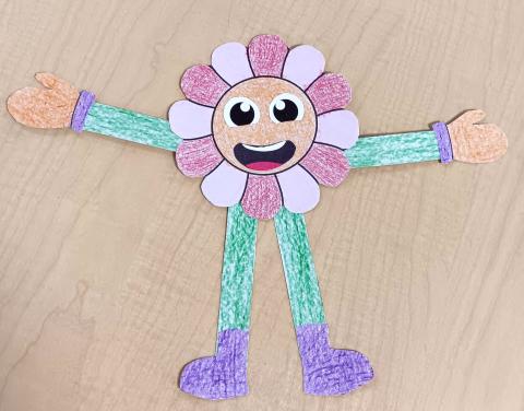 a photo of a pink and red smiling flower person with green arms and legs