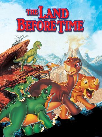 A colorful animated movie poster for The Land Before Time shows a group of young dinosaurs traveling together across a rocky landscape. The characters include a long-neck dinosaur, a three-horned dinosaur, a duck-billed dinosaur, a small green dinosaur, and a flying reptile perched nearby. In the background, mountains and an erupting volcano are visible. Large red text at the top reads “The Land Before Time.”