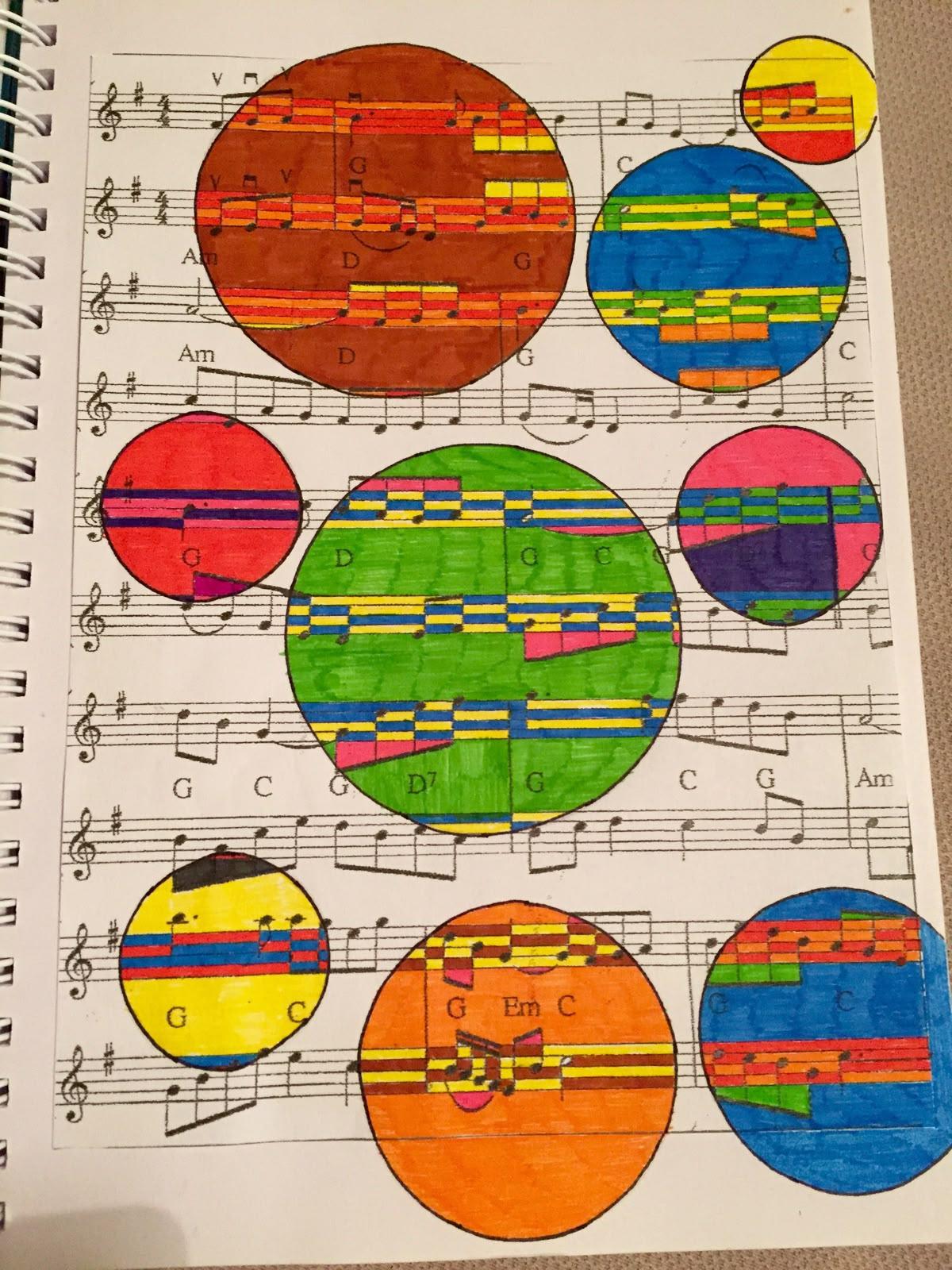 A piece of sheet music with painted multicolor circles of varying sizes and colors