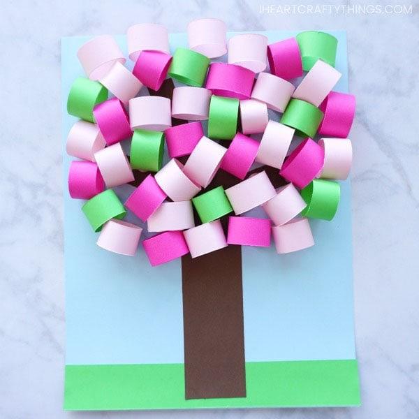 a picture showing a paper tree with pink, purple, and green rolled leaves
