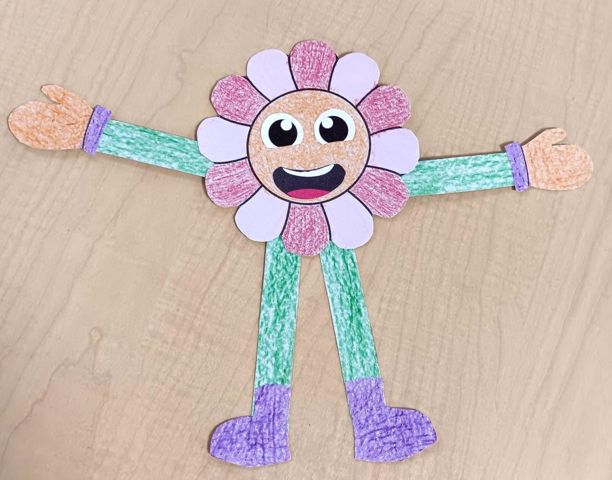 a photo of a pink and red smiling flower person with green arms and legs